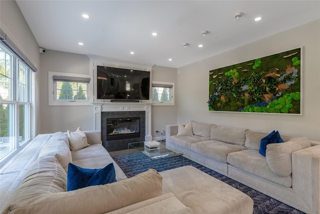 living room featuring a tile fireplace