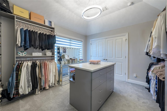 walk in closet featuring light carpet and vaulted ceiling