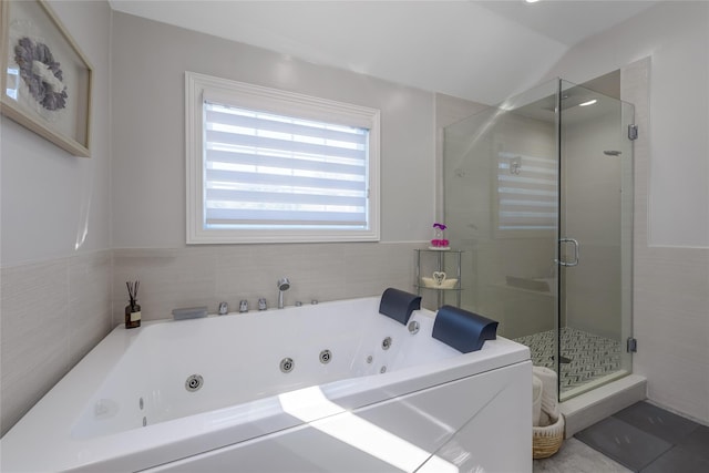 bathroom with tile patterned flooring, separate shower and tub, and lofted ceiling