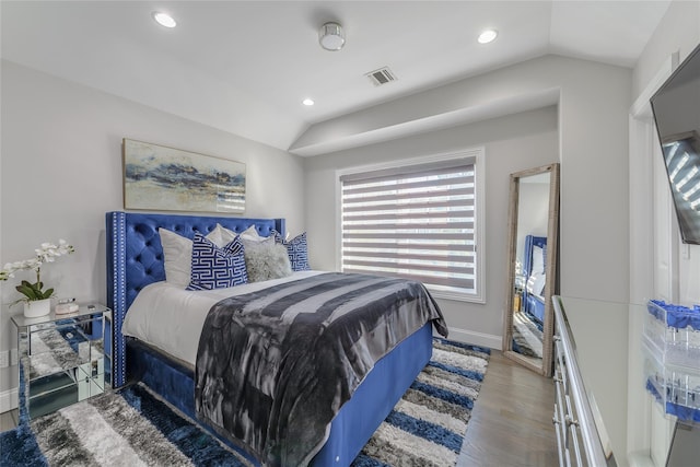 bedroom featuring hardwood / wood-style floors and lofted ceiling