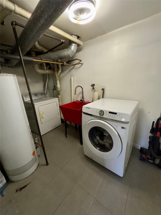 clothes washing area featuring independent washer and dryer, sink, and water heater