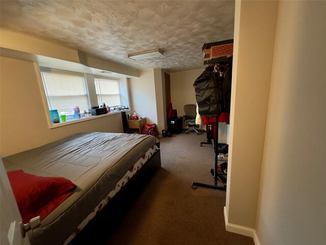 bedroom with carpet floors and a textured ceiling