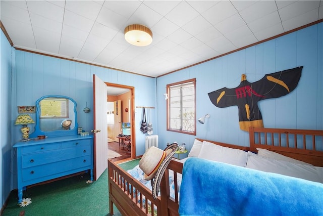 bedroom with radiator heating unit, dark carpet, and ornamental molding