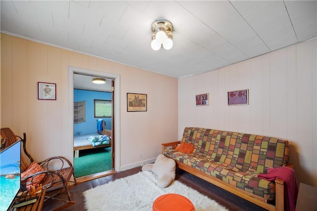 living room with wood walls and dark hardwood / wood-style flooring