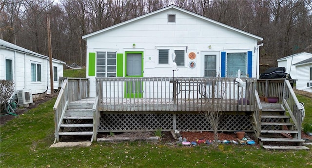 back of property with ac unit and a wooden deck