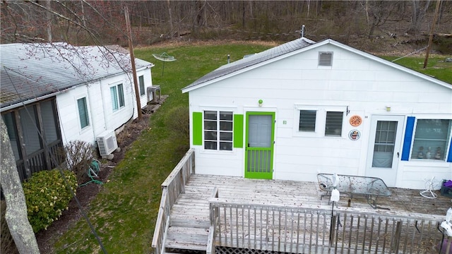 view of front of property featuring a front yard and a wooden deck