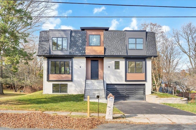 contemporary house featuring a front yard and a garage