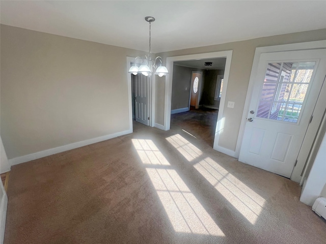 unfurnished dining area with carpet floors and a chandelier