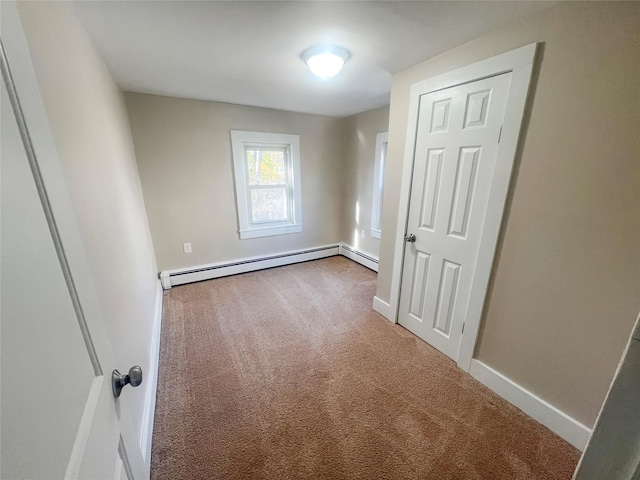 empty room featuring carpet floors and a baseboard radiator