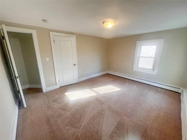 empty room with light colored carpet and a baseboard radiator