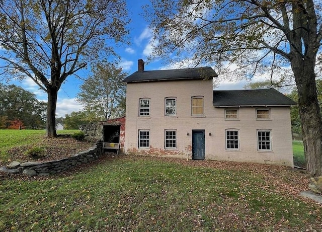 rear view of house with a yard