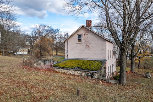 view of property exterior with a lawn