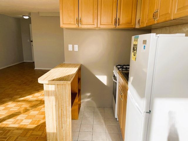 kitchen with light parquet flooring and white fridge