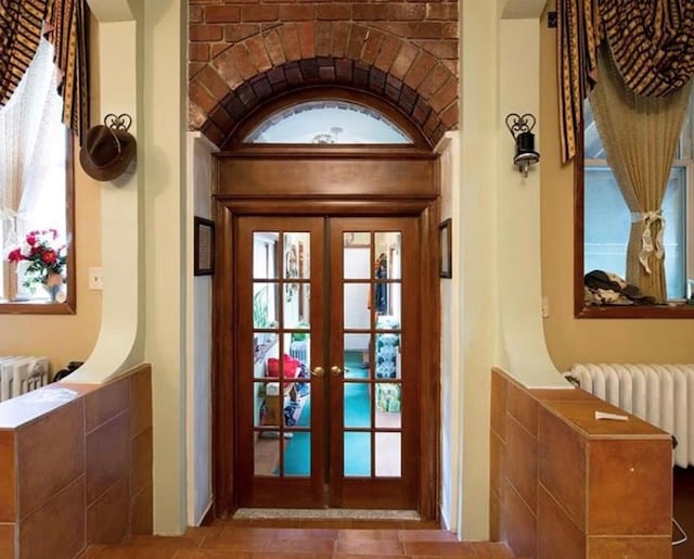 doorway to outside featuring french doors and radiator heating unit