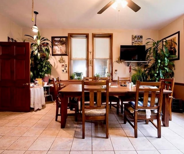 tiled dining area featuring ceiling fan