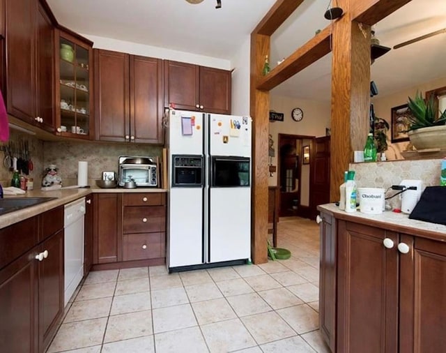 kitchen featuring decorative backsplash, light tile patterned floors, white appliances, and ceiling fan