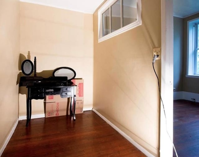 corridor with dark hardwood / wood-style flooring