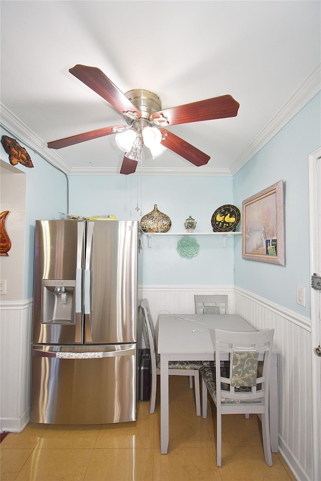 dining space with ceiling fan, light tile patterned floors, and ornamental molding