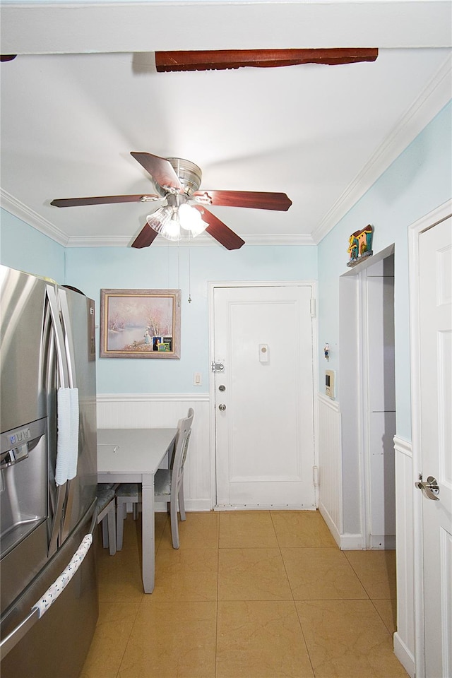 unfurnished dining area featuring ceiling fan, ornamental molding, and light tile patterned floors