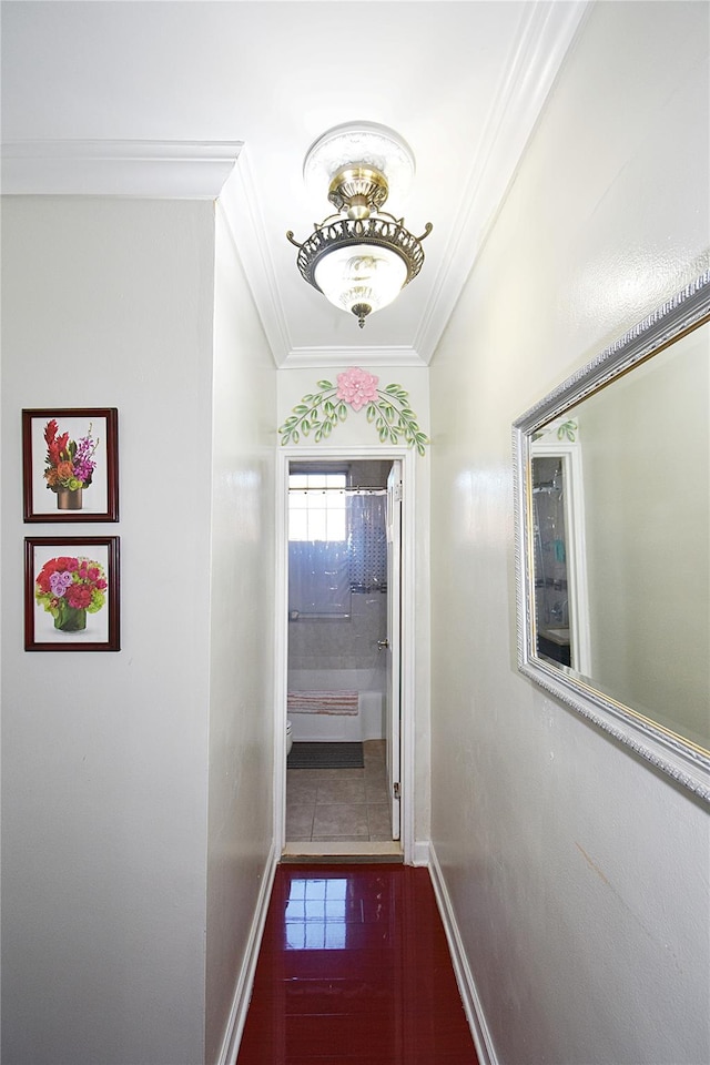 hallway with crown molding and tile patterned flooring