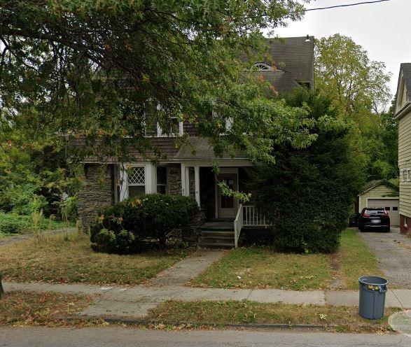 obstructed view of property featuring a garage and an outdoor structure