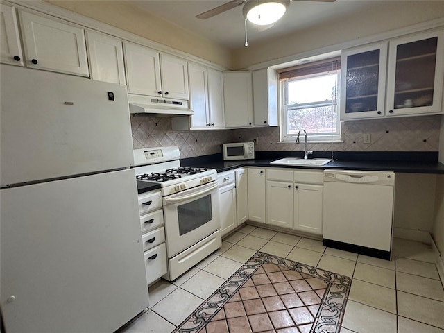 kitchen featuring sink, white cabinetry, light tile patterned floors, white appliances, and backsplash