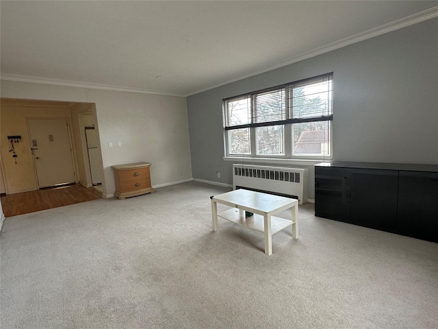 carpeted living room featuring ornamental molding and radiator heating unit