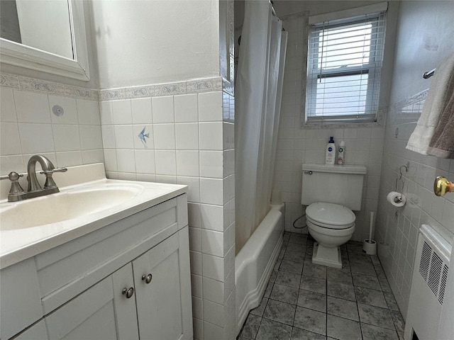 full bathroom with shower / bathtub combination with curtain, radiator, tile walls, vanity, and toilet