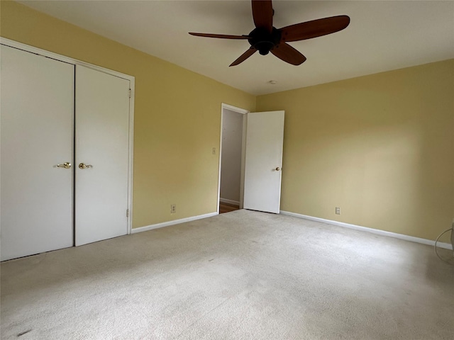 unfurnished bedroom with carpet floors, a closet, and ceiling fan