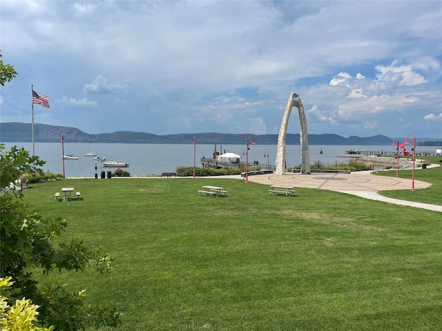 surrounding community with a yard and a water and mountain view