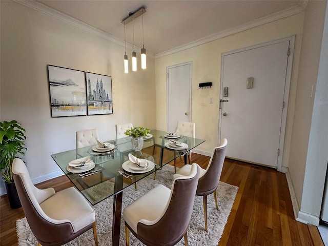 dining room featuring ornamental molding and dark hardwood / wood-style flooring