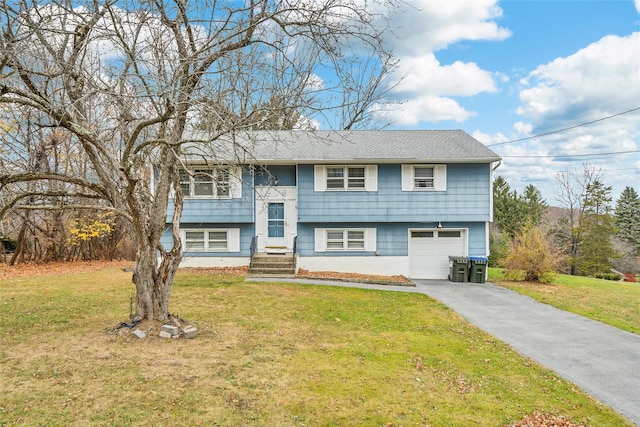 bi-level home featuring a front yard and a garage