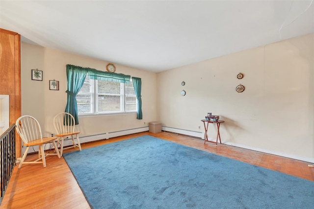 living area with hardwood / wood-style flooring and a baseboard radiator