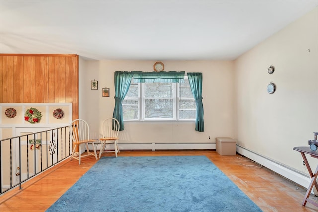 sitting room featuring light hardwood / wood-style flooring and a baseboard heating unit