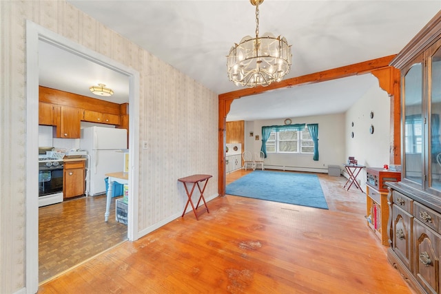 dining room with a notable chandelier, light hardwood / wood-style floors, and baseboard heating