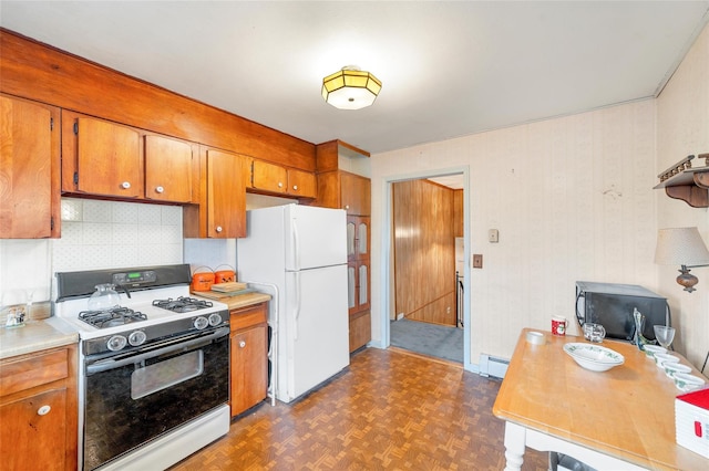 kitchen with decorative backsplash, dark parquet floors, a baseboard radiator, and white appliances