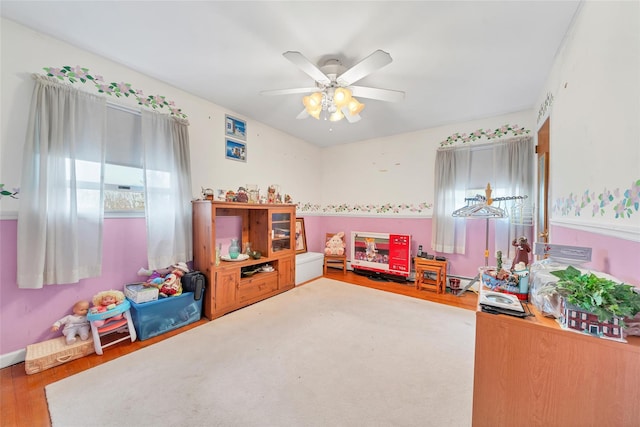 rec room with ceiling fan and wood-type flooring