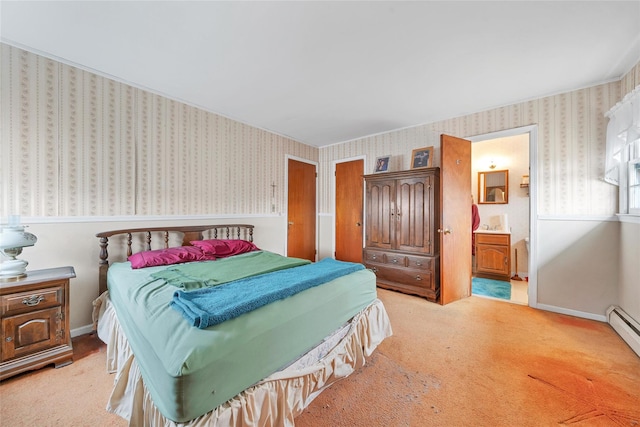 carpeted bedroom with baseboard heating and ensuite bath