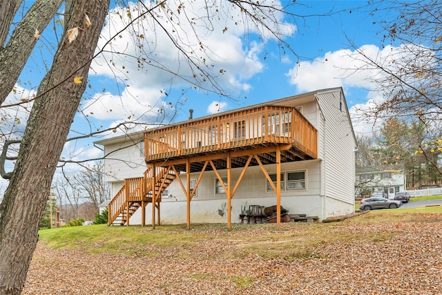 back of house with a deck