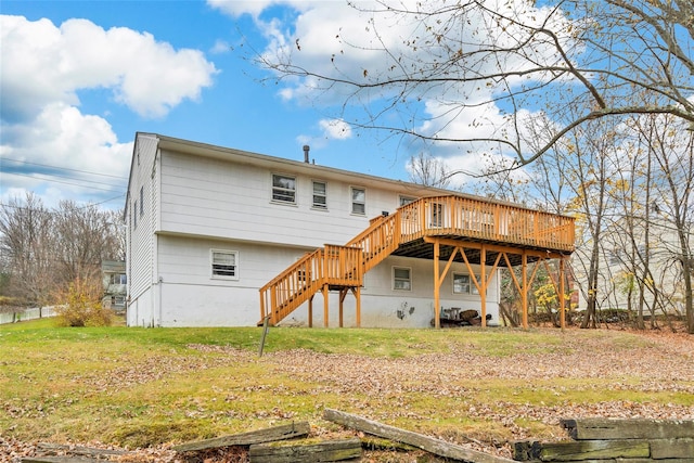 rear view of house featuring a deck and a yard