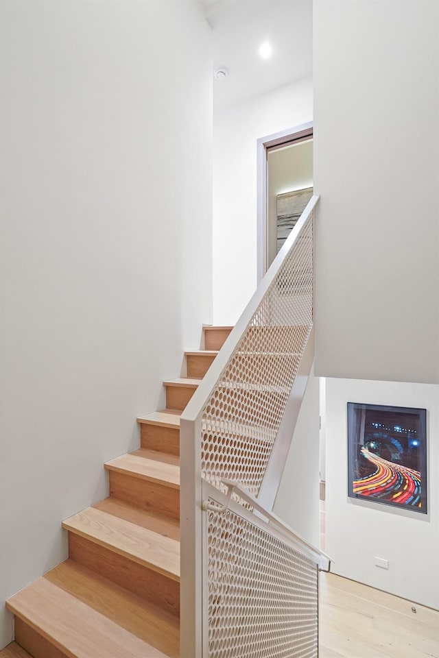 staircase with wood-type flooring