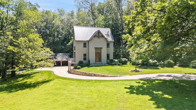 26 Pound Ridge Rd, Pound Ridge, NY 10576 - view of front of property featuring stucco siding, dirt driveway, a front yard, and a metal roof