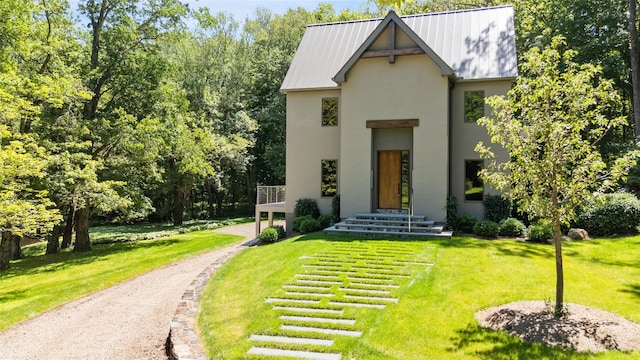 26 Pound Ridge Rd, Pound Ridge, NY 10576 - view of front of house with stucco siding, a front lawn, and driveway