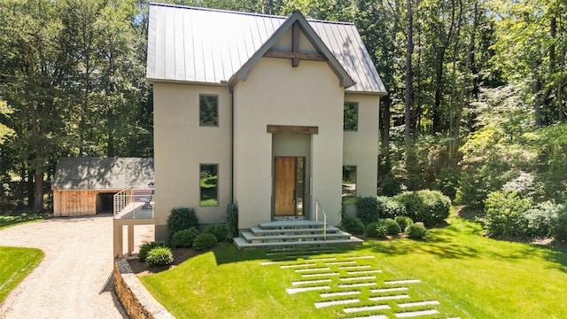 26 Pound Ridge Rd, Pound Ridge, NY 10576 - view of front of home with a standing seam roof, stucco siding, a front lawn, and driveway