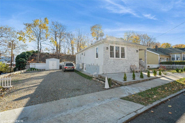 view of front facade featuring a storage shed