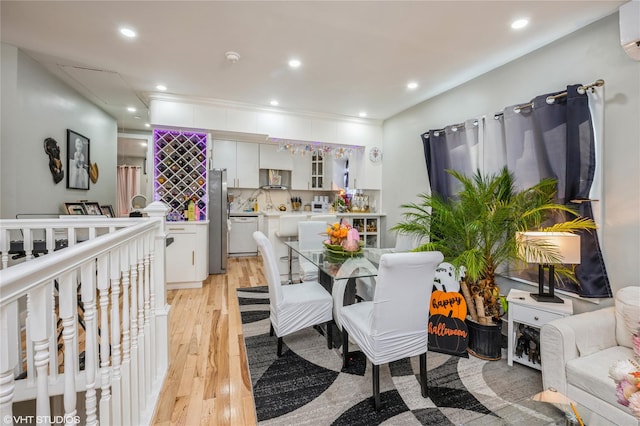 kitchen with tasteful backsplash, white dishwasher, light hardwood / wood-style floors, white cabinetry, and stainless steel refrigerator