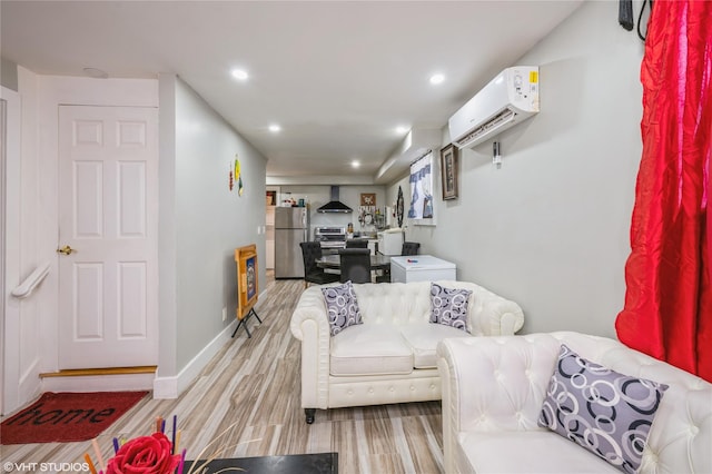 living room featuring light hardwood / wood-style floors and a wall mounted AC