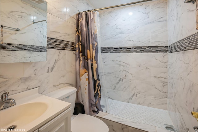 bathroom featuring vanity, curtained shower, toilet, and tile walls