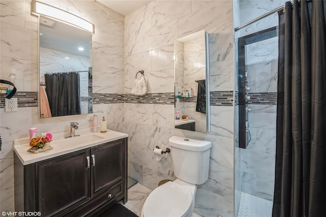 bathroom featuring a shower with shower curtain, vanity, toilet, and tile walls