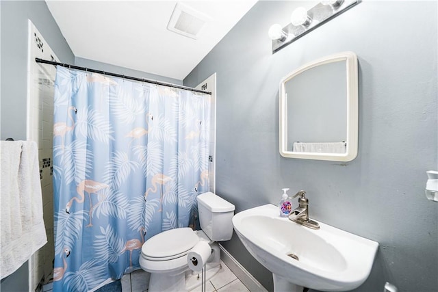 bathroom with sink, toilet, a shower with shower curtain, and tile patterned flooring